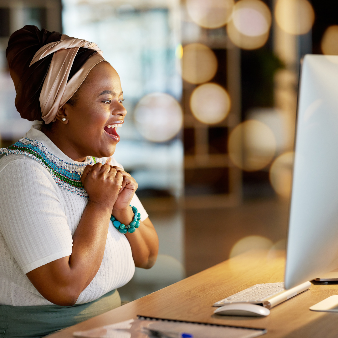 Excited woman looking at her computer